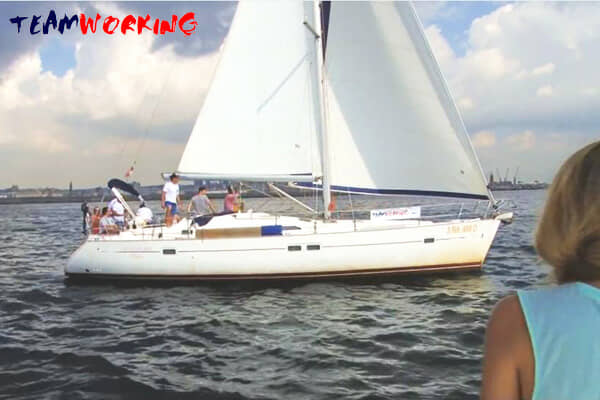 A crew working together on board during a sailing regatta