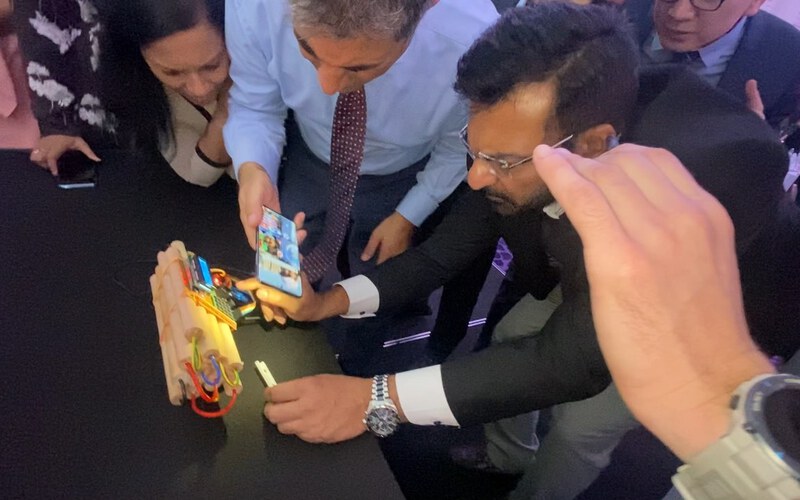 A team working together on the Escape Box device against the clock