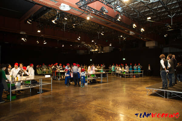 A hall full of teams all cooking at the same time during a big event