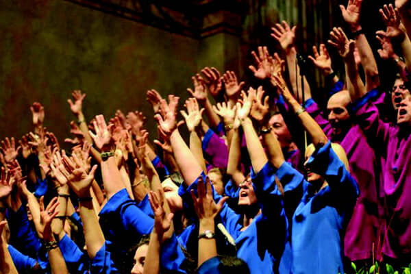 A corporate choir singing together with a choirmaster
