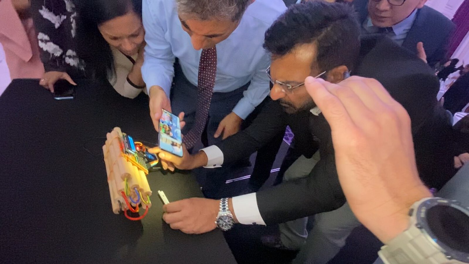 A team around the escape box device, working out the next move against the clock