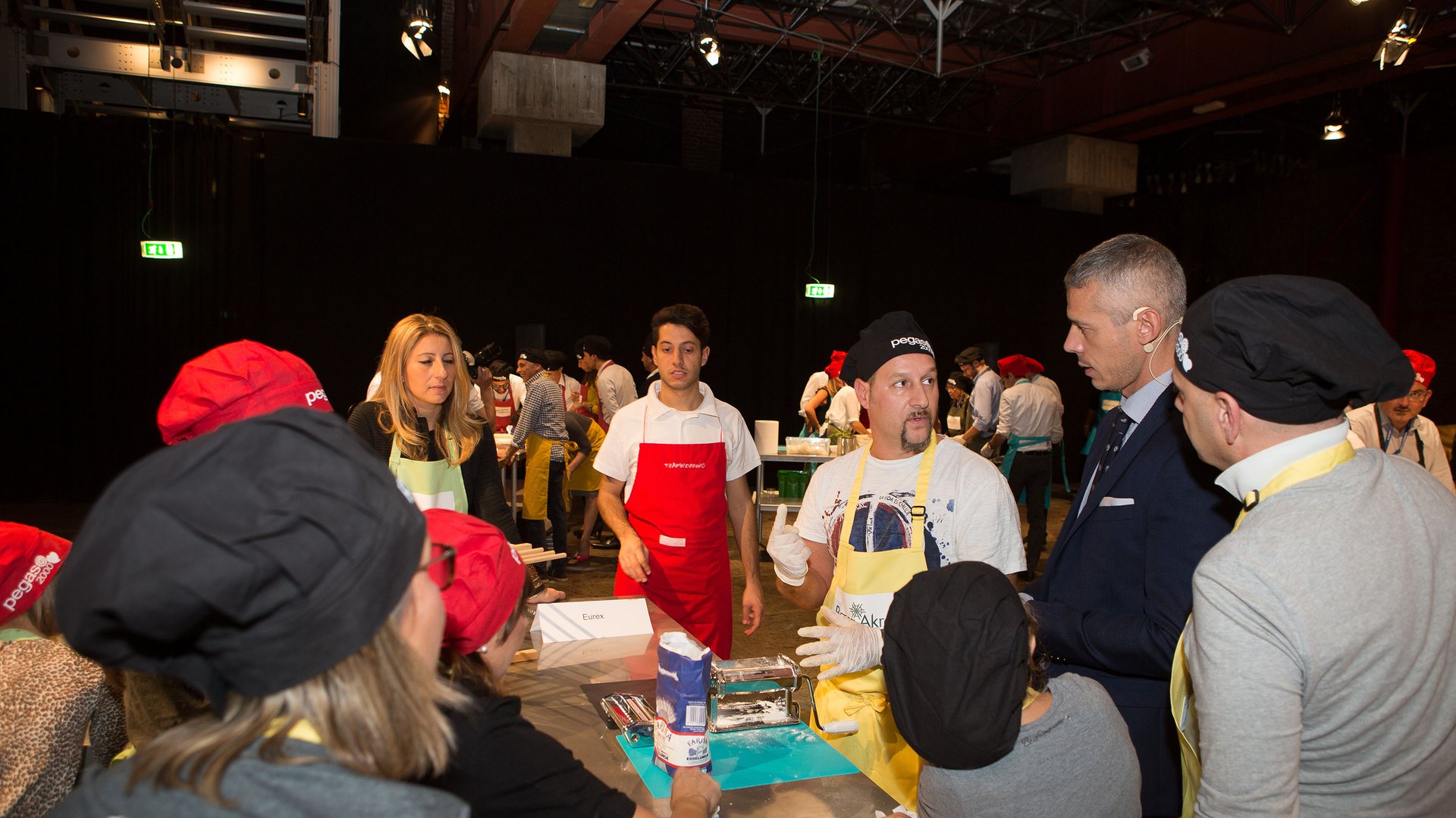 A hall full of teams cooking at the same time during a big event