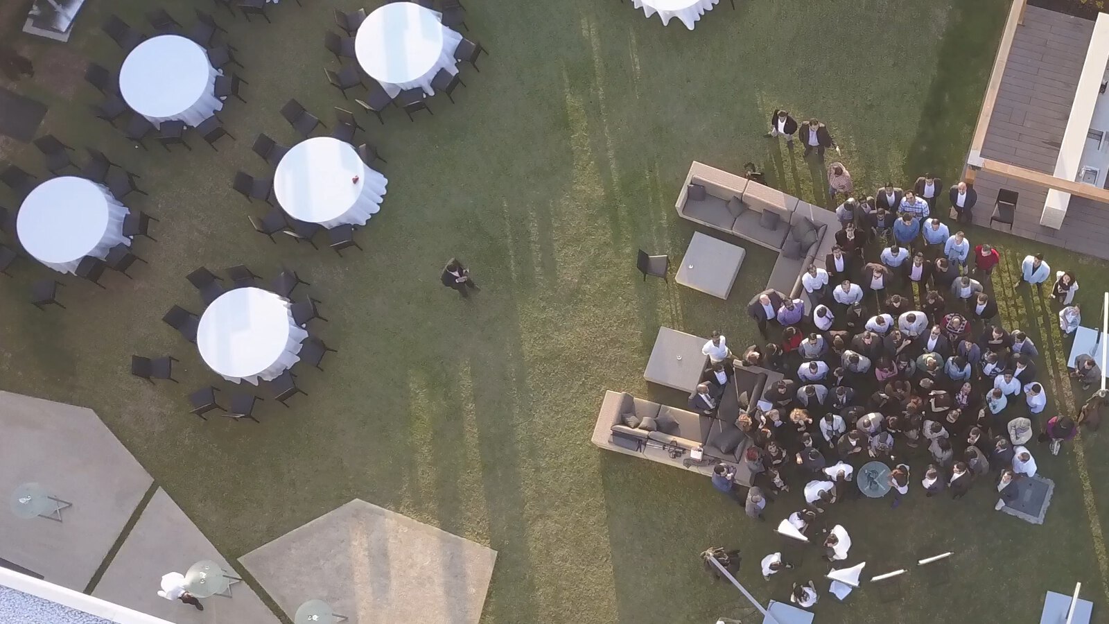 A company event seen from above, the tables laid and the group gathered