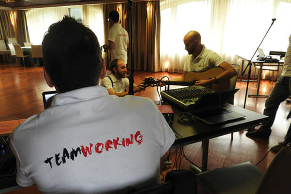 A team writing and recording a company song